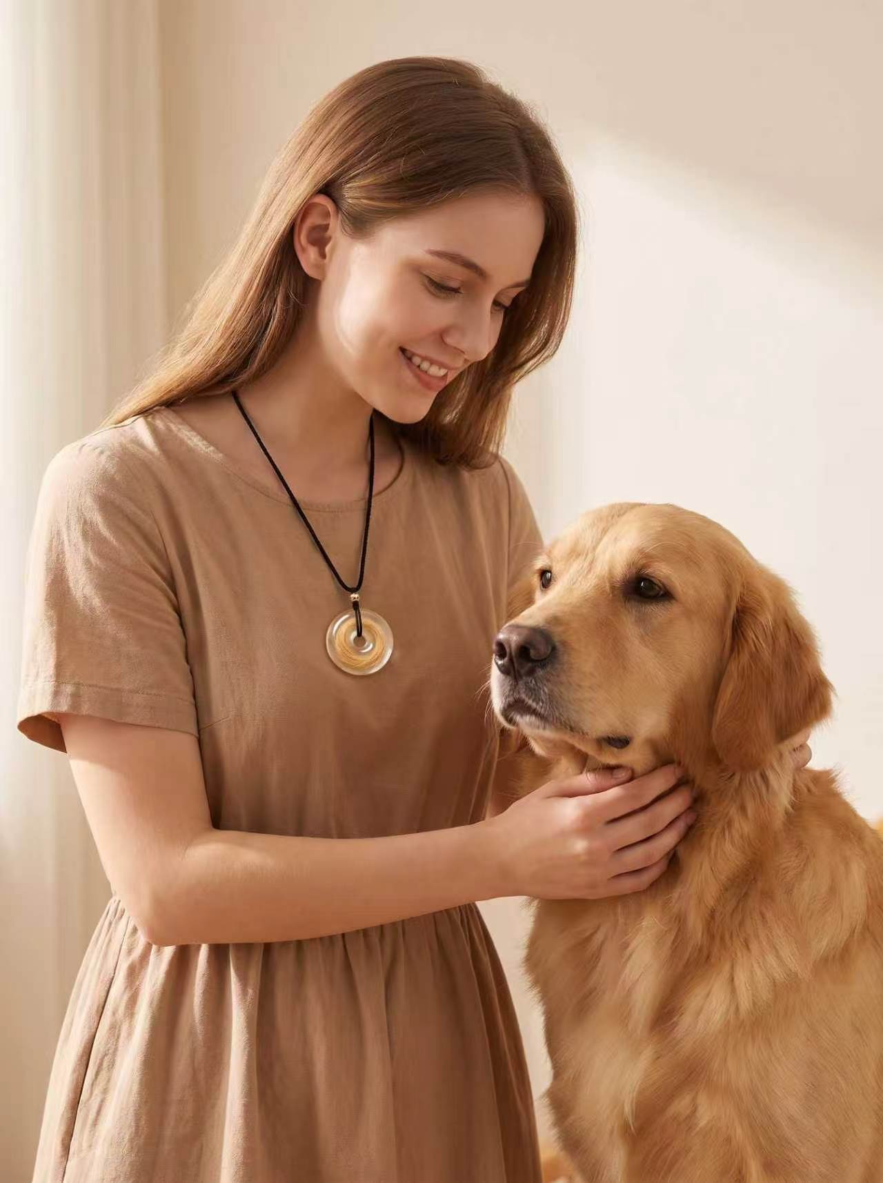 Woman wearing an example round pet hair keepsake beside her dog